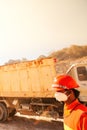 Miner working with mining tool in dusty and baking hot