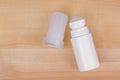 Mineral alum crystal stick next to underarm roll-on deodorant. Natural underarm antiperspirant product