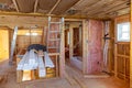 Mineral glass wool in a wooden frame on a inclined wall near the wooden ceiling in a private house