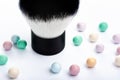 Mineral powder pearls and kabuki makeup brush up close view. Royalty Free Stock Photo