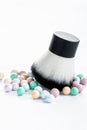 Mineral powder pearls and kabuki makeup brush vertical view. Royalty Free Stock Photo