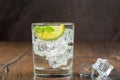 Mineral refreshing water in a glass with ice, mint leaves and lime slice. Royalty Free Stock Photo