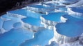 Mineral rich baby blue thermal waters in stunning white terraces of pamukkale, turkey s hillside