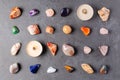 Mineral stones and candles on a black concrete background. The concept of using minerals in astrology and alternative or