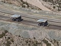 Mineral transport process from the bottom of the mine using huge CAEX mining dump trucks to the processing plant Royalty Free Stock Photo