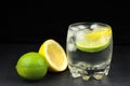 Mineral water in the glass with ice cubes, lime and lemon Royalty Free Stock Photo