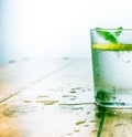 Mineral water infused with limes, lemons, ice and mint leaves on white background, homemade detox soda water recipe