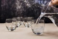 Water from a pitcher poured into a glass. Royalty Free Stock Photo