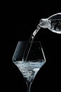 Mineral water is poured into a glass. Black background Royalty Free Stock Photo