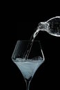 Mineral water is poured into a glass. Black background Royalty Free Stock Photo