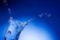 Mineral water splashing out from glass Royalty Free Stock Photo