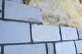 Mineral wool, glass wool house exterior wall insulation with silicate bricks bricklaying. A close-up on building a silicate block