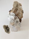 Isolated large hand sample of muscovite mica against white background