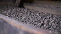 Minerals moving on conveyor belt in factory. Stock footage. Crushing and processing plant of minerals. Stone ore on Royalty Free Stock Photo