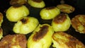Minerals and vitamins. Roasted potatoes close-up. Halves of potatoes in a pan.