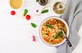 Minestrone, italian vegetable soup with pasta on white table.