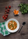 Minestrone soup with pasta and herbs. Italian Cuisine. Dark wooden background. Place for text