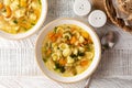 Minestrone soup with pasta orecchiette and seasonal vegetables. on a light table, top view. Delicious vegetarian italian food Royalty Free Stock Photo