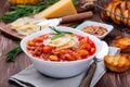 Minestrone soup served with crispy bread, on wooden background, horizontal Royalty Free Stock Photo