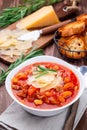 Minestrone soup served with crispy bread, on wooden background, vertical Royalty Free Stock Photo