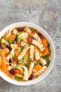 Minestrone soup. Vegetable soup with fresh tomato, celery, carrot, zucchini, onion, pepper, beans and pasta. Dish of italian cuisi Royalty Free Stock Photo