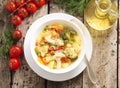 Minestrone vegetable soup with tomato, celery, carrot, zucchini, broccoli. Top view, gray rustic wooden table Royalty Free Stock Photo