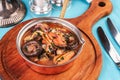 Minestrone stew soup with mushrooms, fish meat, squids, mussels, greens, tomatoes and shrimps Royalty Free Stock Photo