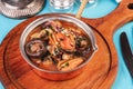 Minestrone stew soup with mushrooms, fish meat, squids, mussels, greens, tomatoes and shrimps Royalty Free Stock Photo