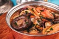 Minestrone stew soup with mushrooms, fish meat, squids, mussels, greens, tomatoes and shrimps Royalty Free Stock Photo