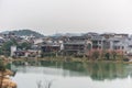 Ming Qing Dynasty Chinese traditional rural house at the lakeside, built with black tiles, stone, and bricks, in Qingyan Ancient