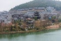 Ming Qing Dynasty Chinese traditional rural house at the lakeside, built with black tiles, stone, and bricks, in Qingyan Ancient