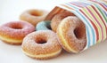 Mini apple cider donuts are packaged in a small white and red striped paper bag, image Royalty Free Stock Photo