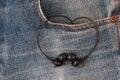 Mini audio headphones in pocket denim pants