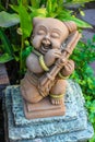 Mini baby playing musical instrument statuary