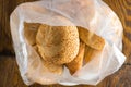 Mini baguette long loaf pastries in a transparent bag on a white background