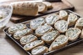 Mini baguettes with herb garlic butter, ready to be baked on a tray