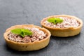 Mini banoffee pie tarts isolated on black stone background