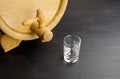 Mini barrel and glass on black wooden background