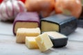 Mini black and dark red waxed cheddar cheeses with strong flavor made from West Country milk and and age-old methods with onion