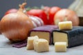 Mini black and dark red waxed cheddar cheeses with strong flavor made from West Country milk and and age-old methods with onion