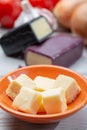 Mini black and dark red waxed cheddar cheeses with strong flavor made from West Country milk and and age-old methods with onion