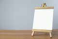 A mini blank whiteboard on wooden table