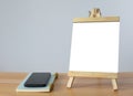 A mini blank whiteboard on wooden table