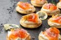 Mini blini pancakes with soft cheese, cold smoked salmon and dill Royalty Free Stock Photo