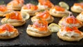 Mini blini pancakes with soft cheese, cold smoked salmon and dill Royalty Free Stock Photo