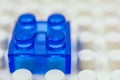 Mini blue building block on white block Royalty Free Stock Photo