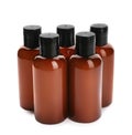 Mini bottles with cosmetic products on white. Hotel amenities Royalty Free Stock Photo