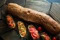 Mini bruschetta with tomatoes, salmon, avocado, bacon, and basil butter Royalty Free Stock Photo