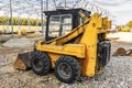 A mini excavator bulldozer is on the construction site. Royalty Free Stock Photo