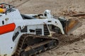 Mini bulldozer with earth doing landscaping works Royalty Free Stock Photo